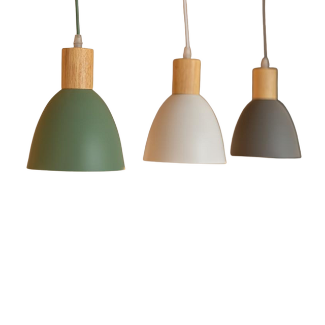 Three pendant lights with wooden tios and colorful shades on a white background